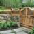 This beautiful rock wall with redwood fencing makes a beautiful barrier between the front and back gardens. You'll notice the "pickets" in the fence are 3/4" copper. 
 